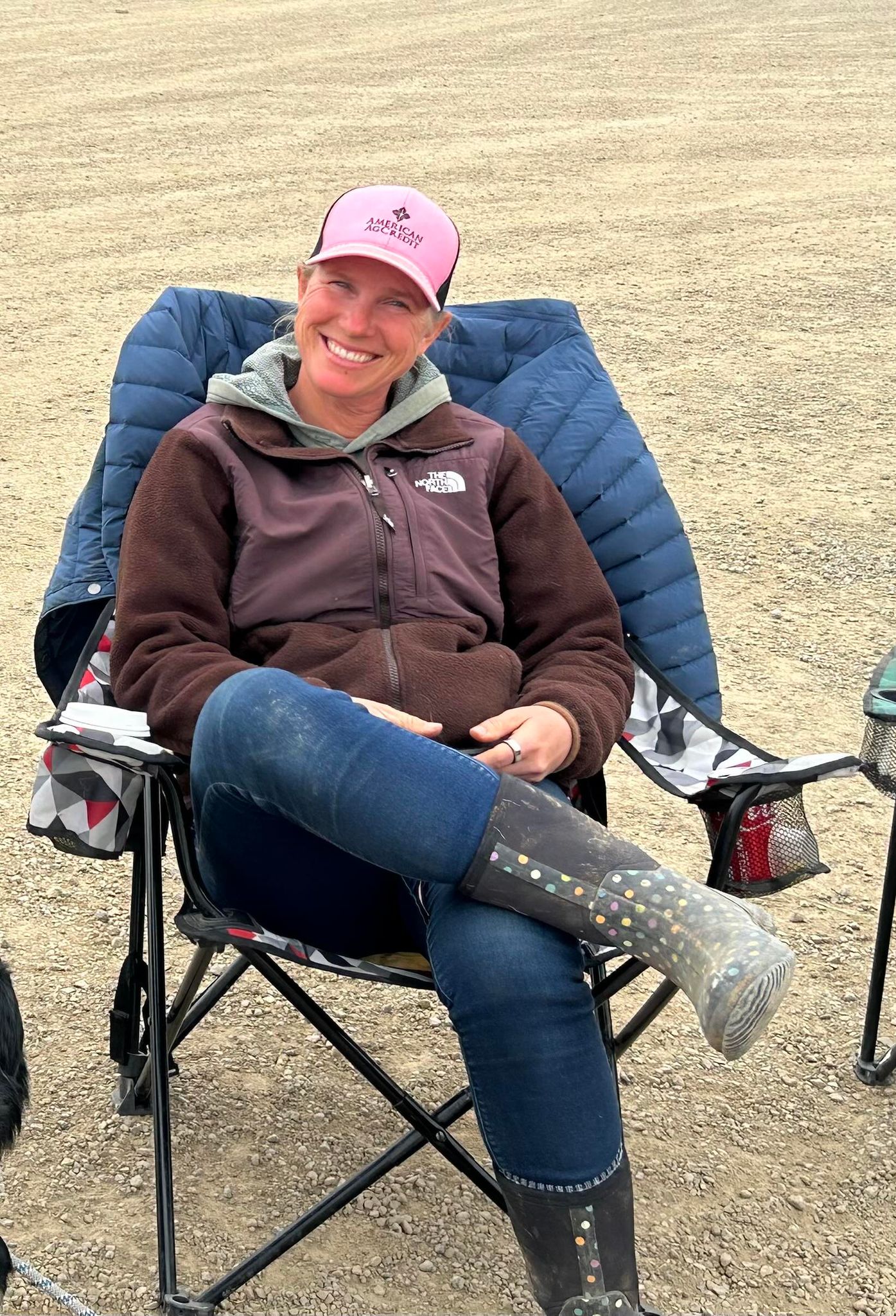 Hana sitting in a camp chair watching a stock dog event